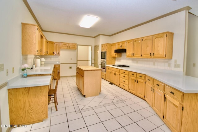 1689 Peppertree Dr, Alcoa, TN 37701 - kitchen with tasteful backsplash, cooktop, ornamental molding, under cabinet range hood, and light countertops
