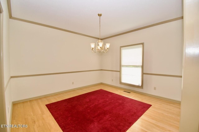 1689 Peppertree Dr, Alcoa, TN 37701 - spare room featuring wood finished floors, a chandelier, and ornamental molding