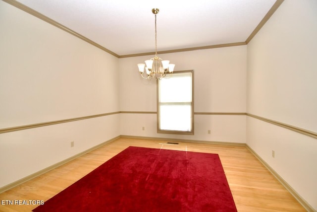 1689 Peppertree Dr, Alcoa, TN 37701 - empty room with ornamental molding, wood finished floors, and a chandelier