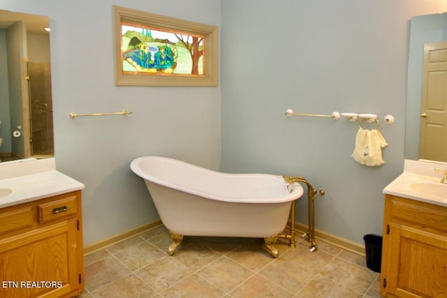 1689 Peppertree Dr, Alcoa, TN 37701 - bathroom featuring two vanities, a soaking tub, and a stall shower