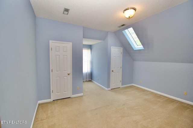 1689 Peppertree Dr, Alcoa, TN 37701 - additional living space with a skylight, light colored carpet, lofted ceiling, and plenty of natural light