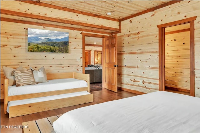 bedroom featuring wood walls, wooden ceiling, and wood finished floors