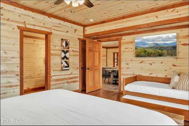 bedroom featuring a mountain view, wood walls, wood finished floors, and wood ceiling