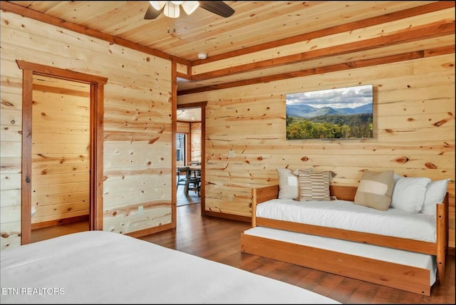 bedroom featuring wooden ceiling, wood finished floors, and wood walls