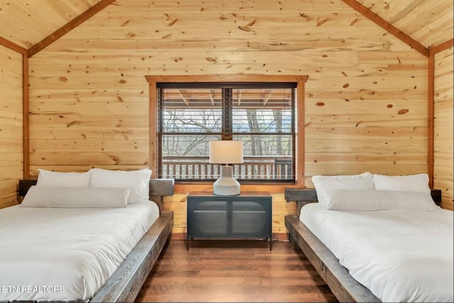 bedroom featuring lofted ceiling, wood ceiling, wooden walls, and wood finished floors