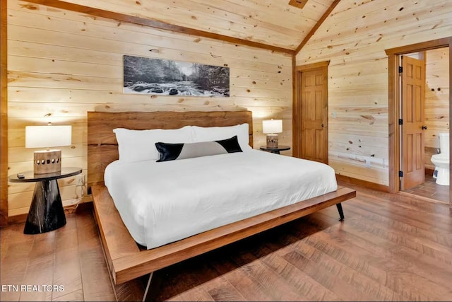 bedroom with lofted ceiling, wooden walls, ensuite bath, wood finished floors, and wooden ceiling