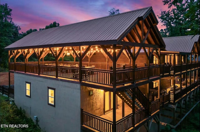 back of property featuring metal roof