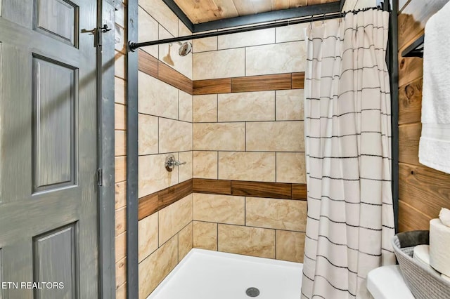 bathroom with toilet and a shower stall