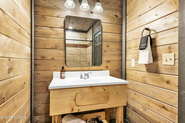 bathroom with wooden walls and vanity