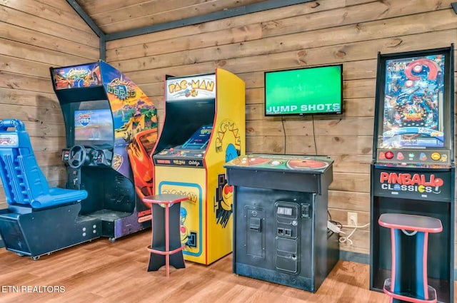 game room with lofted ceiling, wooden ceiling, wood finished floors, and wooden walls