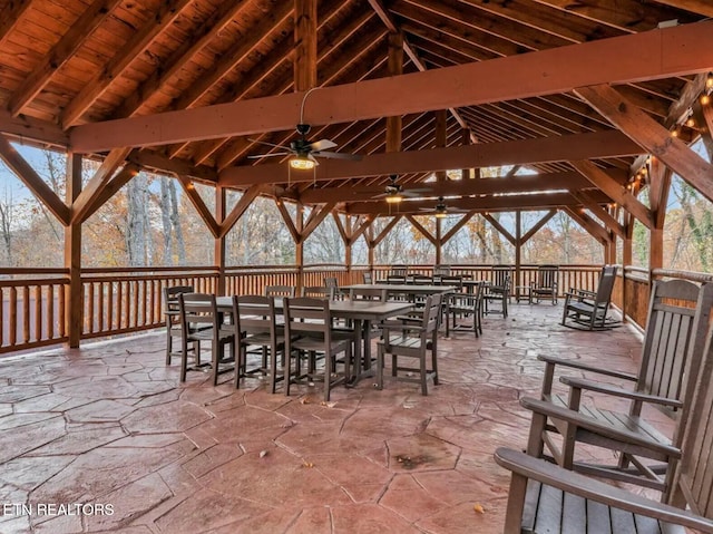 view of patio with a gazebo, outdoor dining area, and a ceiling fan