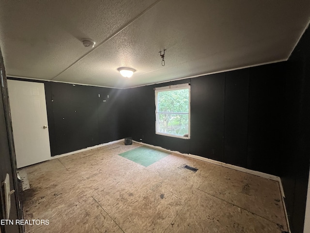 unfurnished room with a textured ceiling and visible vents