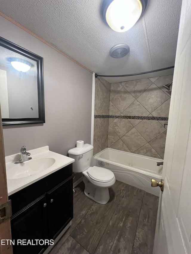 bathroom featuring a textured ceiling, vanity, wood finished floors, and toilet