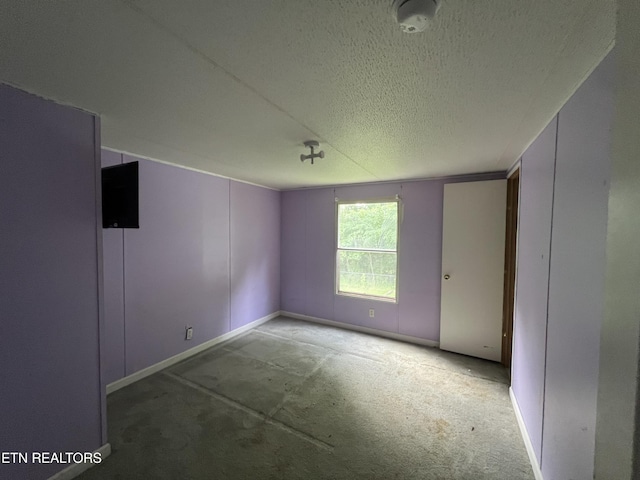 spare room with a textured ceiling