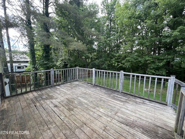 wooden terrace with a lawn