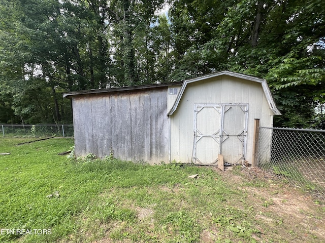 view of shed featuring fence