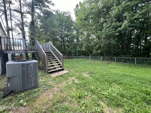 view of yard featuring central AC unit, stairway, fence, and a wooden deck