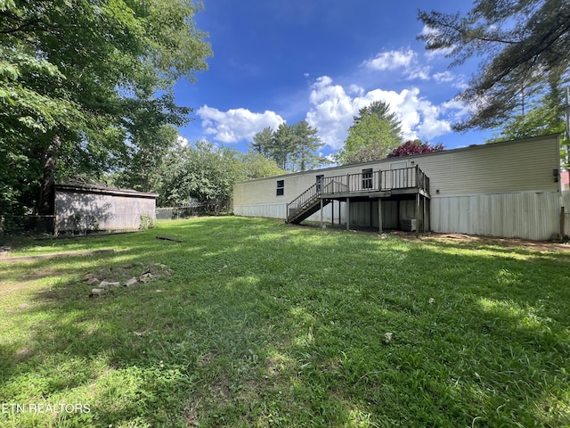 view of yard with stairs, fence, and a deck