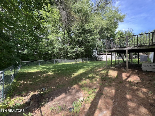 view of yard featuring a deck, stairway, and a fenced backyard