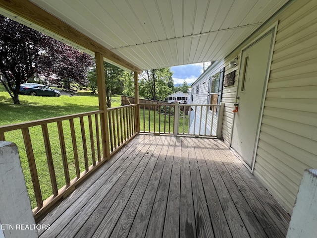 wooden deck featuring a yard