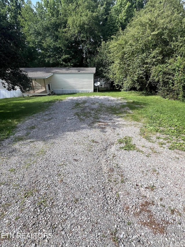 exterior space with driveway and fence