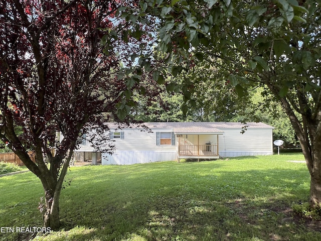 exterior space with a deck and a front lawn