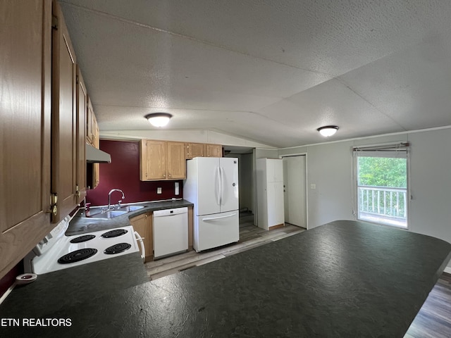 kitchen featuring dark countertops, vaulted ceiling, a sink, light wood-type flooring, and white appliances