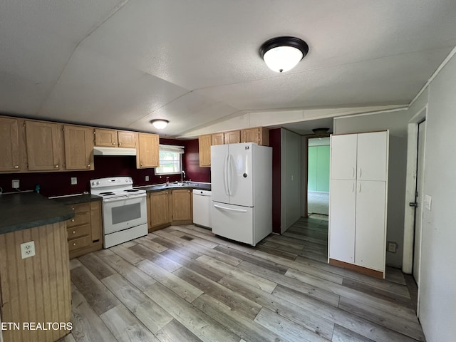 kitchen with dark countertops, light wood-style flooring, vaulted ceiling, white appliances, and under cabinet range hood