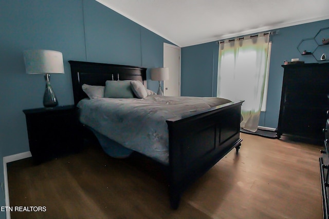 bedroom featuring vaulted ceiling and wood finished floors