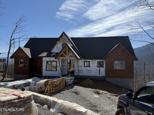 property under construction with french doors and roof with shingles