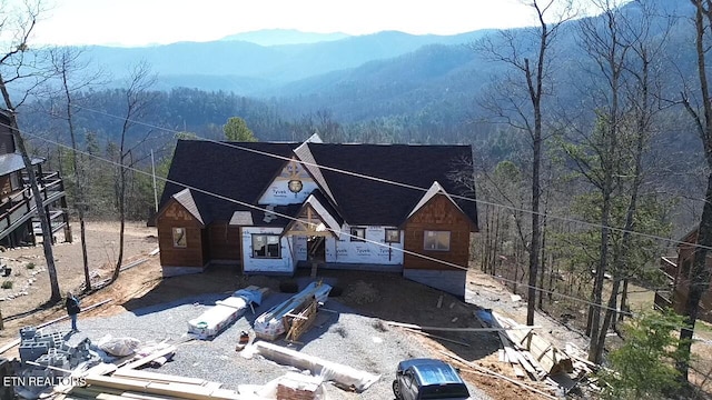 property in mid-construction with a mountain view and a view of trees