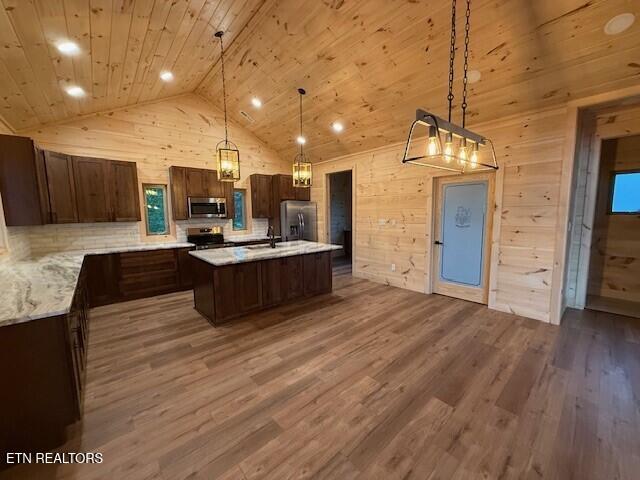 1841 Pinestand Ridge Way, Sevierville, TN 37862 - kitchen with appliances with stainless steel finishes, vaulted ceiling, wood finished floors, wooden walls, and wood ceiling