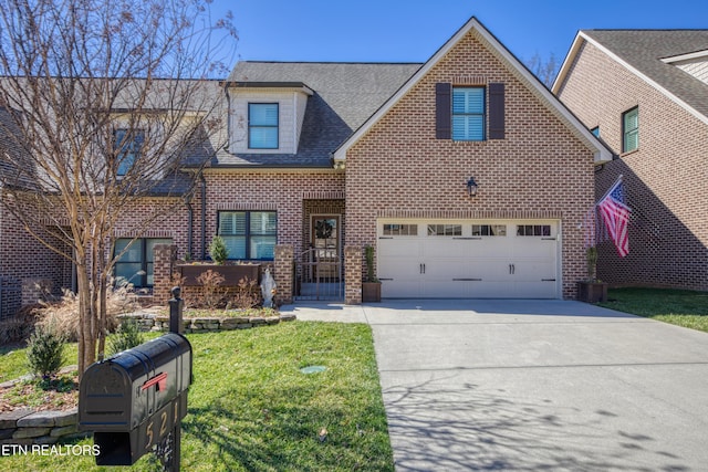 view of front of property with driveway, brick siding, and a front lawn