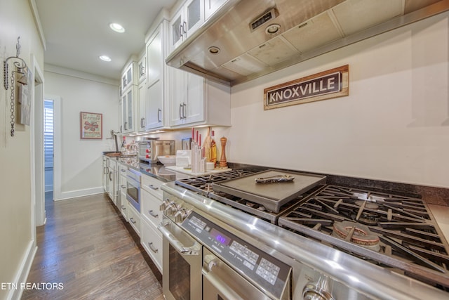 kitchen featuring range with two ovens, dark wood-style flooring, baseboards, white cabinets, and glass insert cabinets