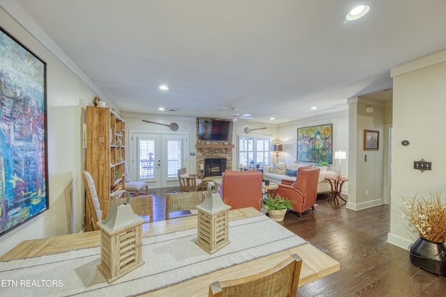 dining room featuring french doors, a fireplace, recessed lighting, wood finished floors, and baseboards