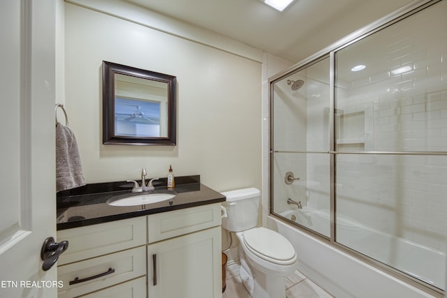 full bath with toilet, shower / bath combination with glass door, and vanity