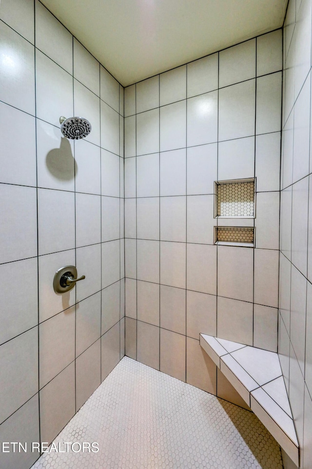 full bathroom with tiled shower