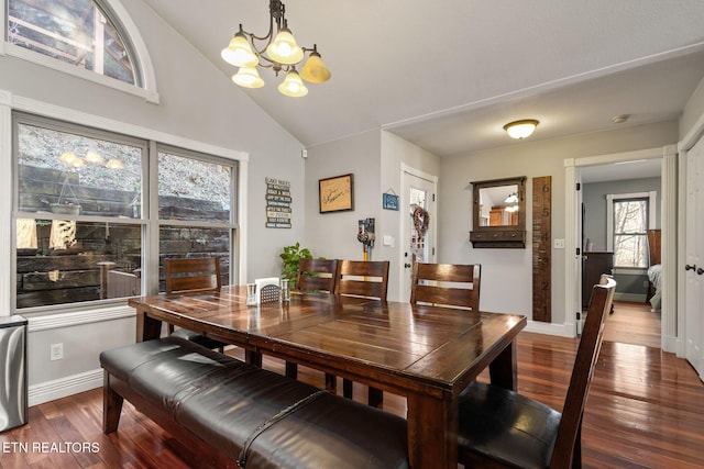 dining room with vaulted ceiling, baseboards, wood finished floors, and an inviting chandelier