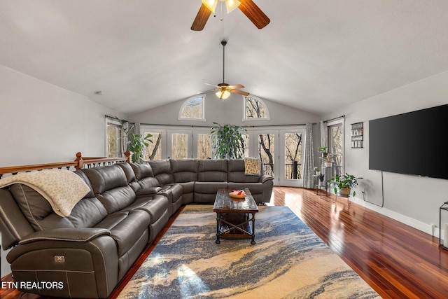 living area featuring french doors, ceiling fan, vaulted ceiling, wood finished floors, and baseboards