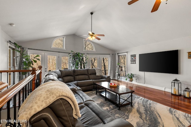 living room with baseboards, ceiling fan, wood finished floors, french doors, and high vaulted ceiling