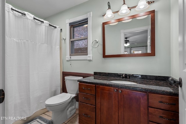 full bath with toilet, a wainscoted wall, a shower with shower curtain, vanity, and tile patterned floors