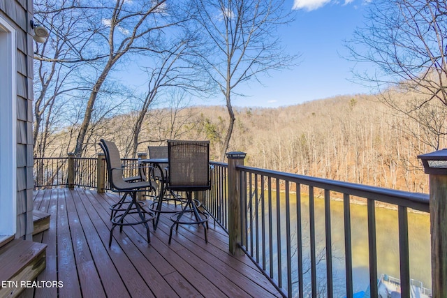 wooden terrace with a wooded view