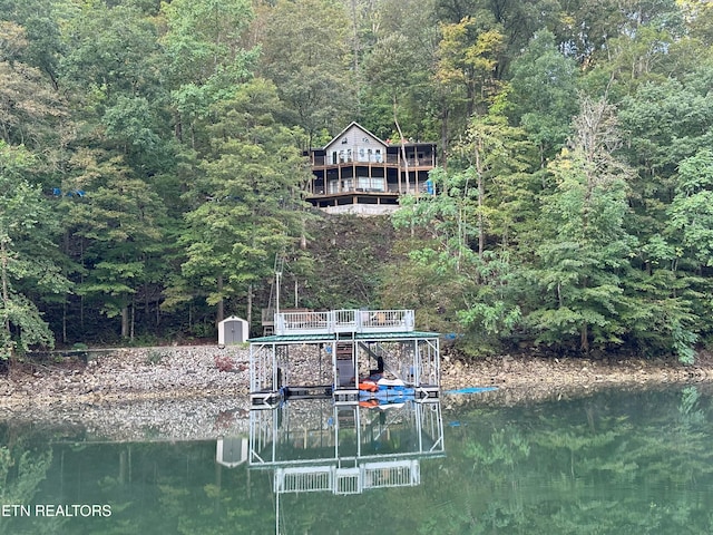 dock area featuring a water view and a view of trees