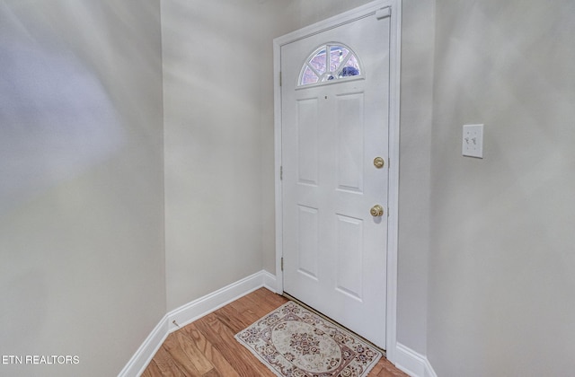 doorway to outside with light wood-style floors and baseboards