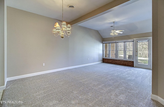 spare room featuring baseboards, visible vents, vaulted ceiling, carpet floors, and ceiling fan with notable chandelier