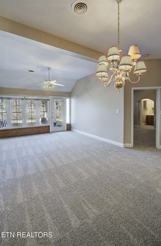 unfurnished living room featuring carpet, visible vents, arched walkways, and baseboards