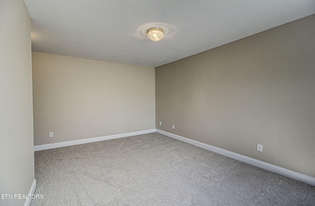 carpeted empty room with baseboards