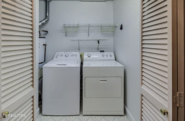 washroom with washing machine and dryer and laundry area