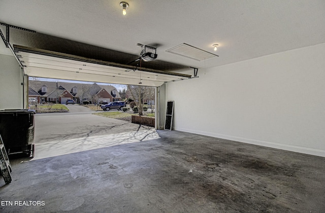 garage with a residential view, baseboards, and a garage door opener