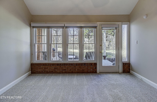 interior space featuring baseboards and vaulted ceiling